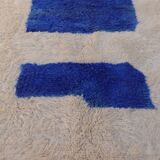 White Moroccan rug with abstract Klein blue patterns