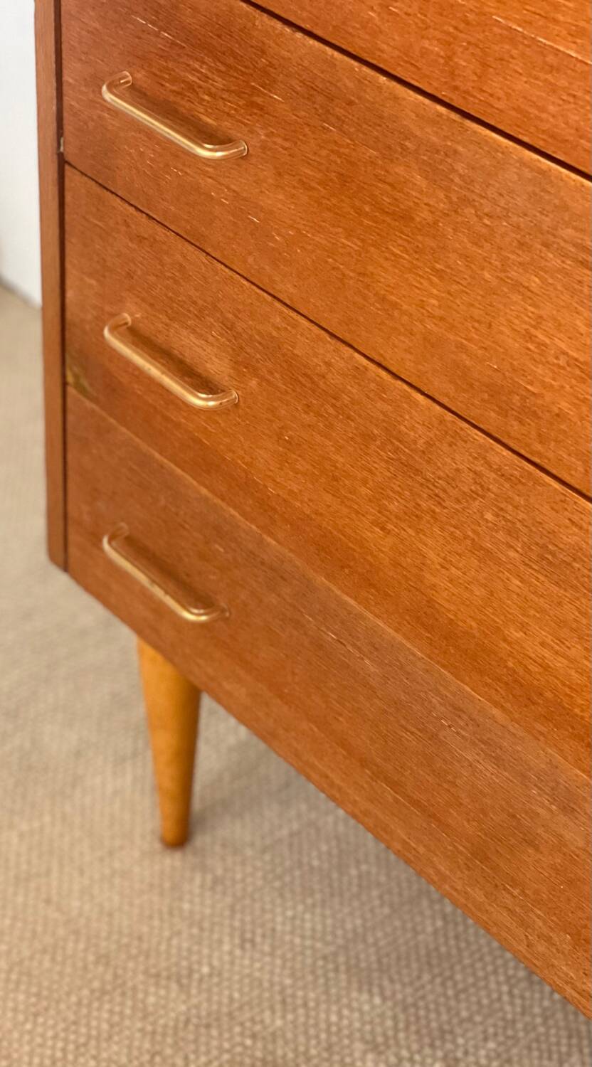 Vintage 1960s chest of drawers with covered handles.