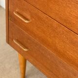 Vintage 1960s chest of drawers with covered handles.