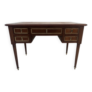 Louis XVI style desk in mahogany and mahogany veneer, 20th century.