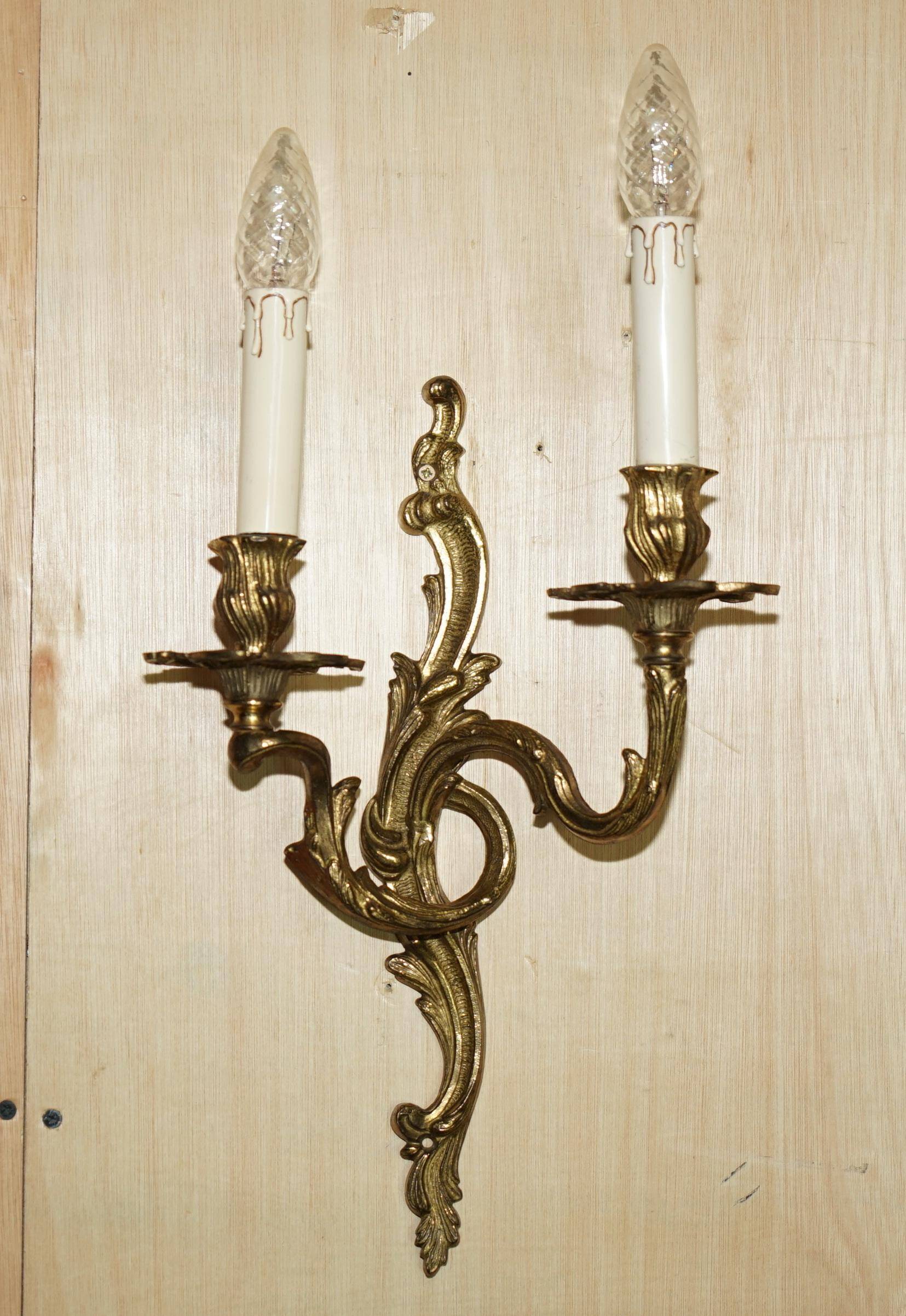 Pair of antique wall sconces from the 1920s in gilded bronze.