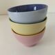 Set of three pastel two-tone mini bowls in glazed ceramic.