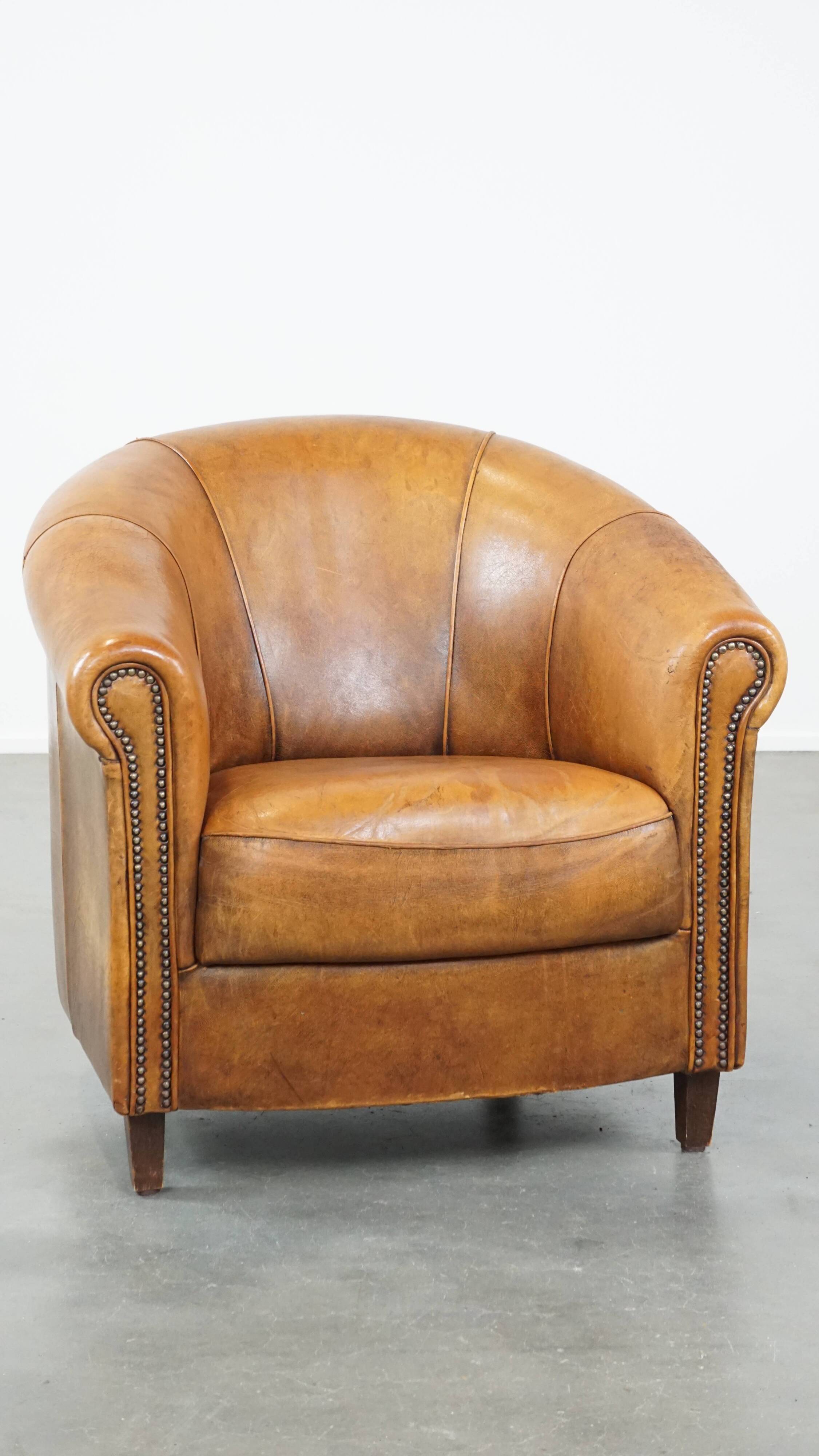 Cognac-colored sheep leather club chair with patina