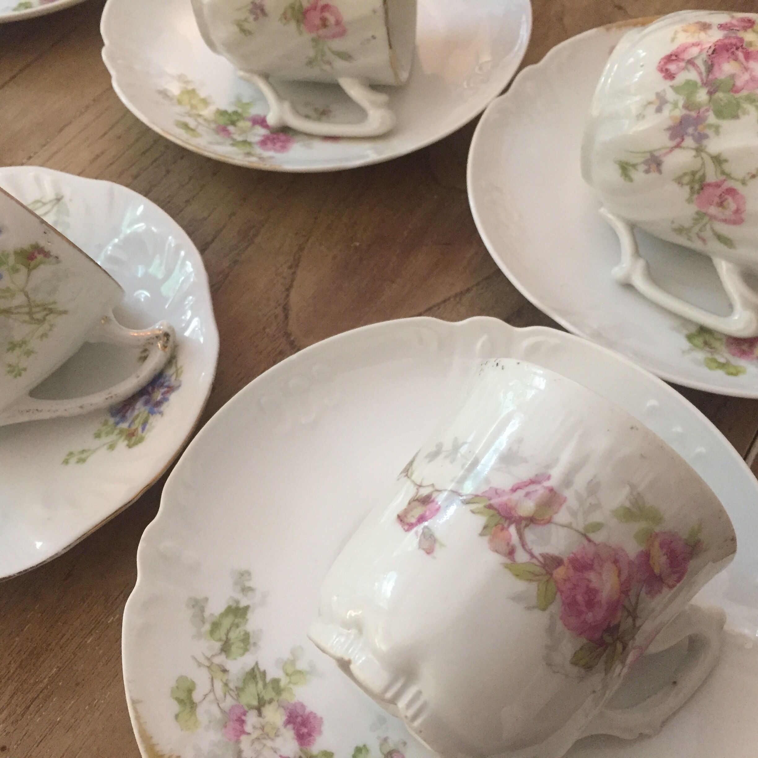 6 antique cups and mismatched saucers