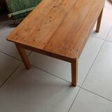 Coffee table with raw wood and a large drawer.