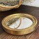 Miroir rond en bois de couleur dorée