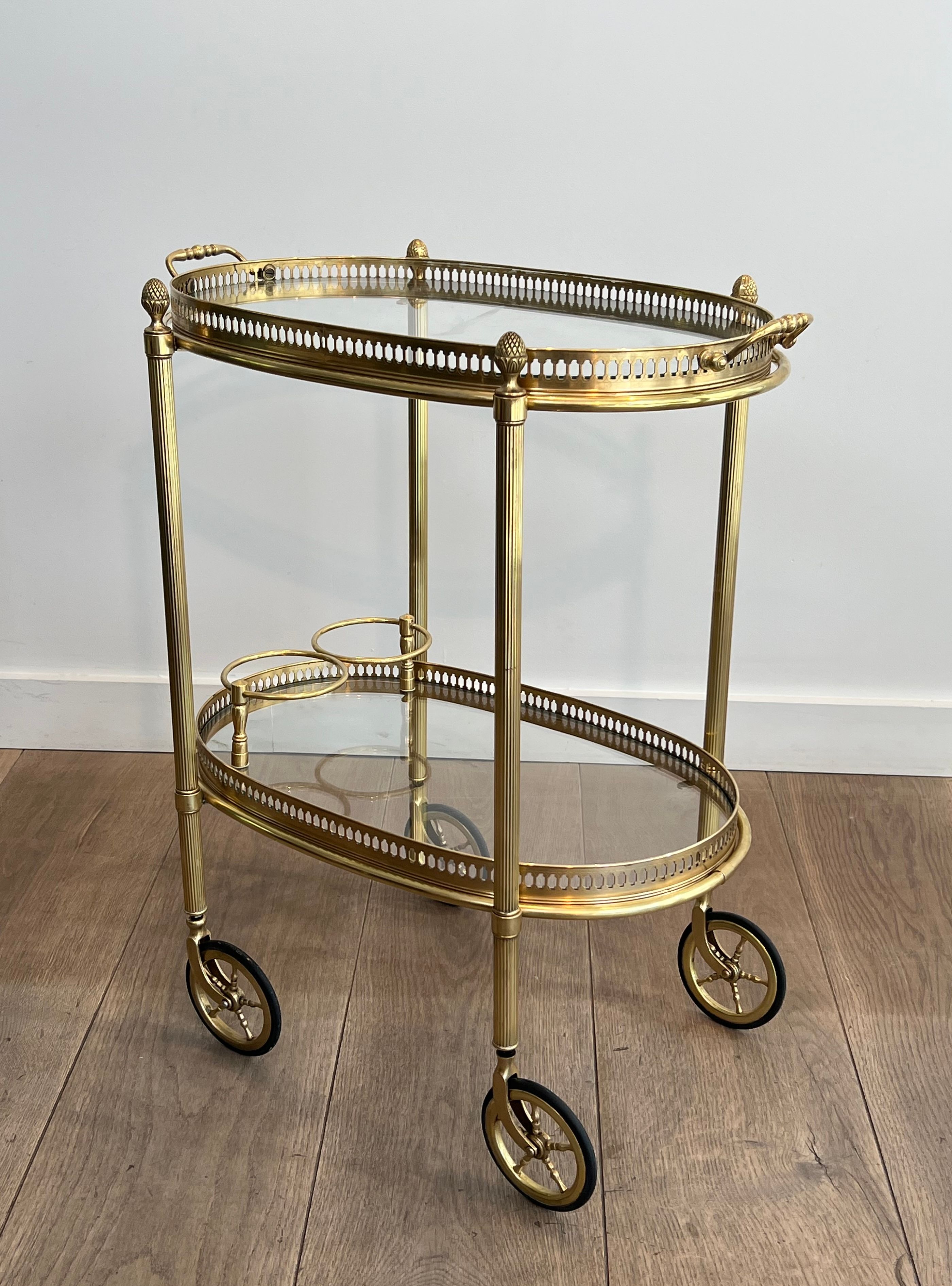 Small oval rolling table in brass with double removable trays from Maison Bagués.