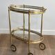Small oval rolling table in brass with double removable trays from Maison Bagués.