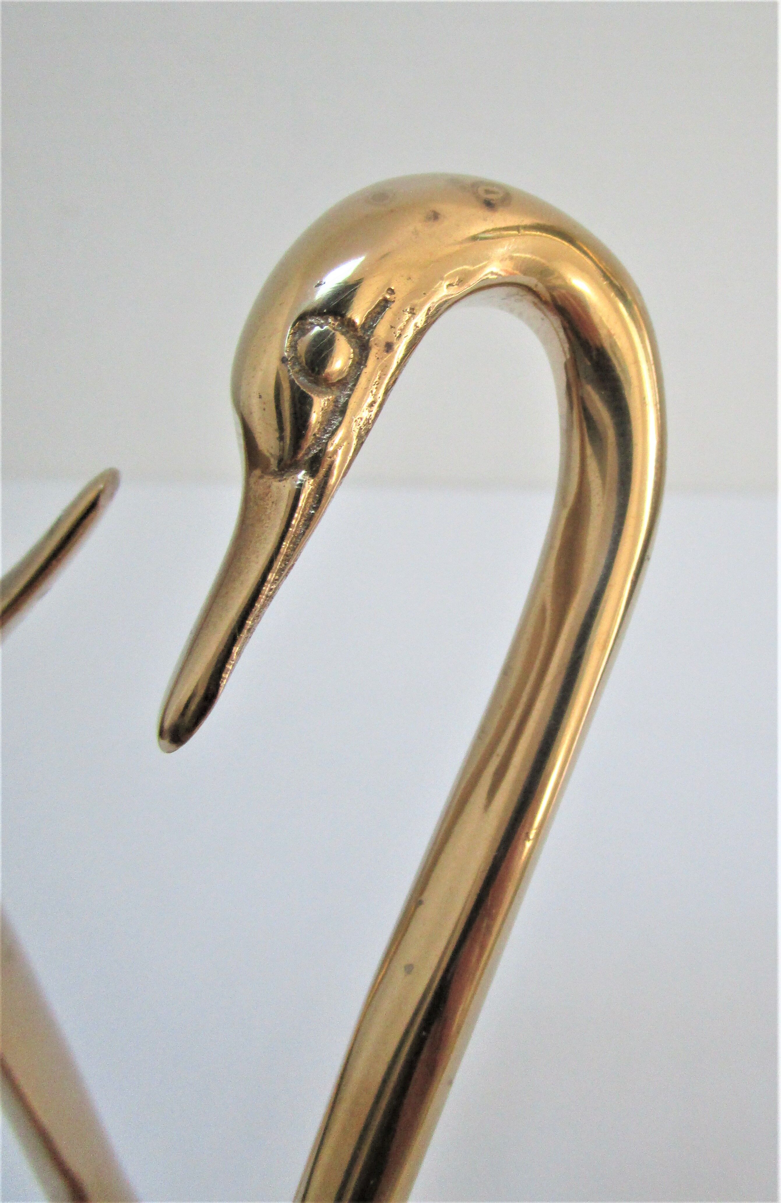 Pair of stylized birds in solid brass