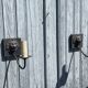 Two lion head wall sconces in tin.