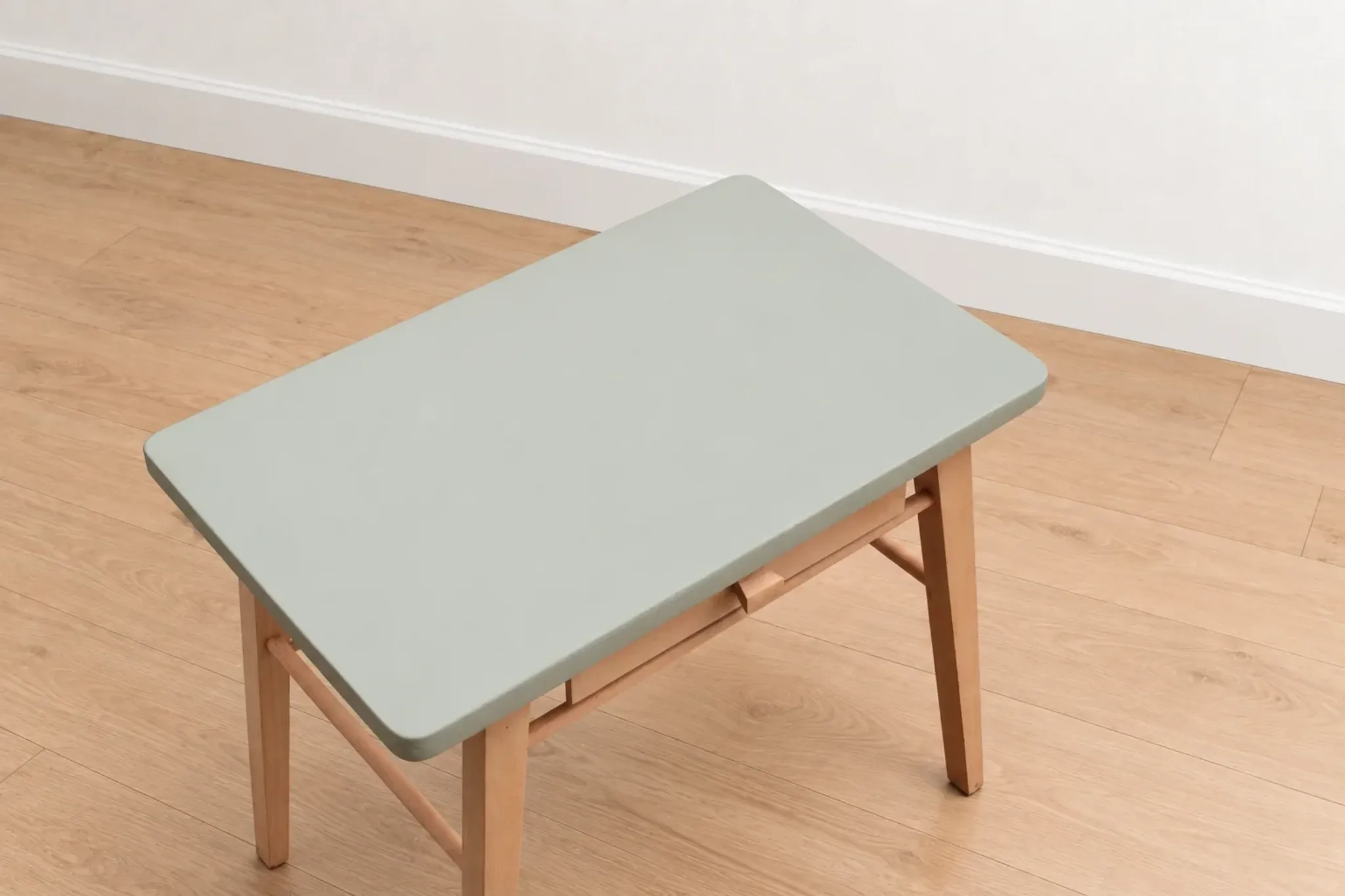 Small vintage children's desk attributed to Baumann – natural wood and lizard green top.