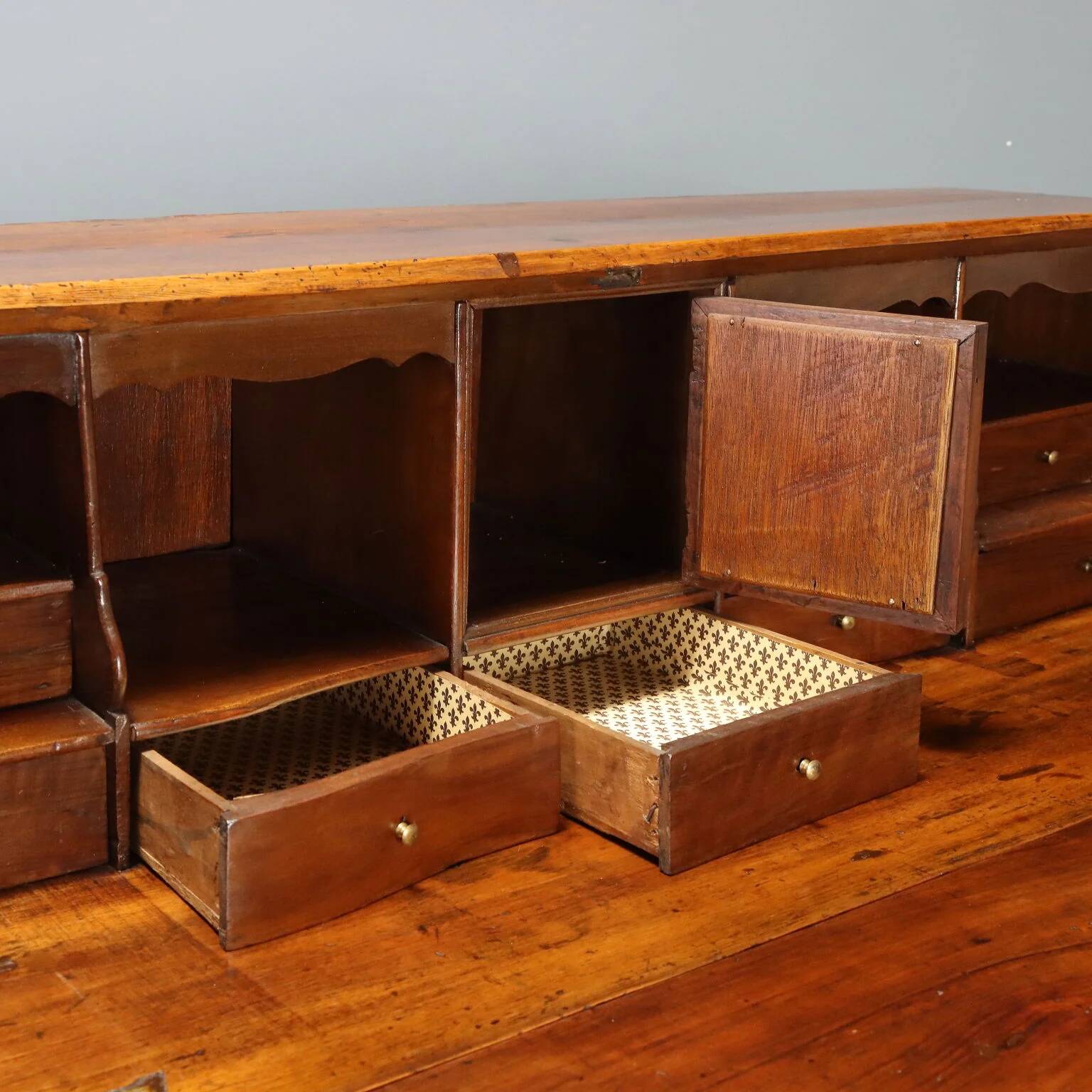 Antique drop-leaf cabinet in walnut with maple inlays, Italy, mid-18th century.