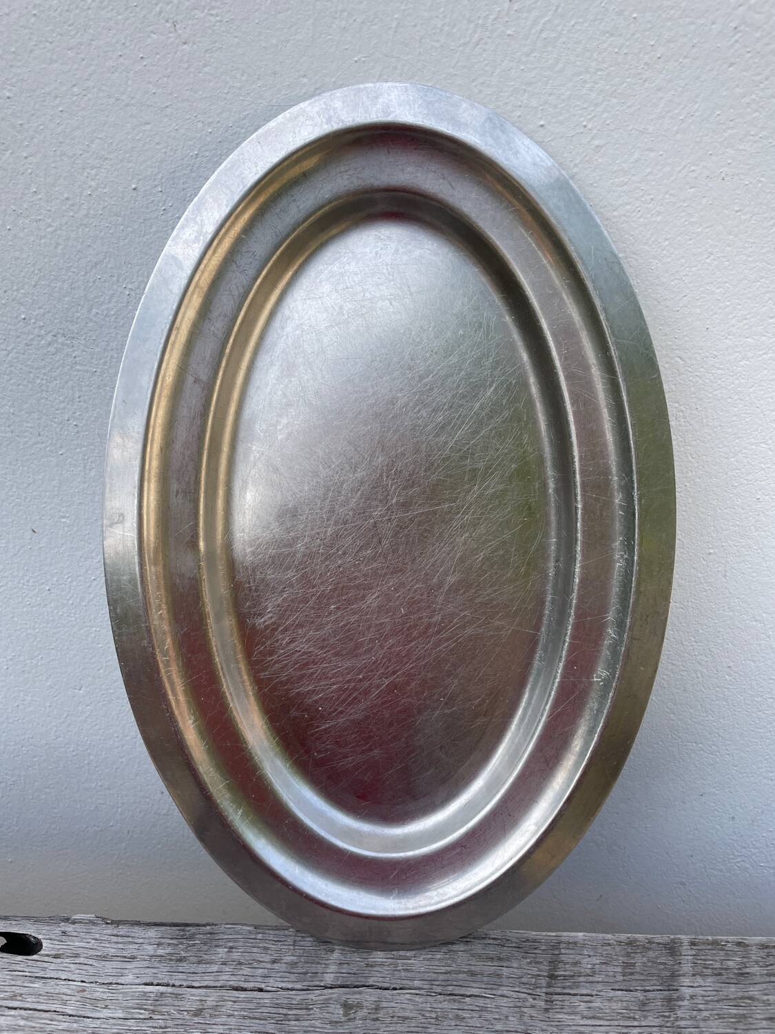 Oval stainless steel dish, signed Rémi Letang