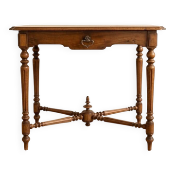 Antique walnut desk with a drawer and turned legs.