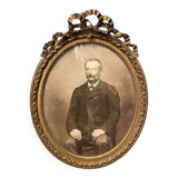 Old ancestor portrait in a gilded oval frame with Louis XVI style knot decoration
