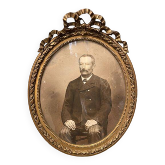 Old ancestor portrait in a gilded oval frame with Louis XVI style knot decoration