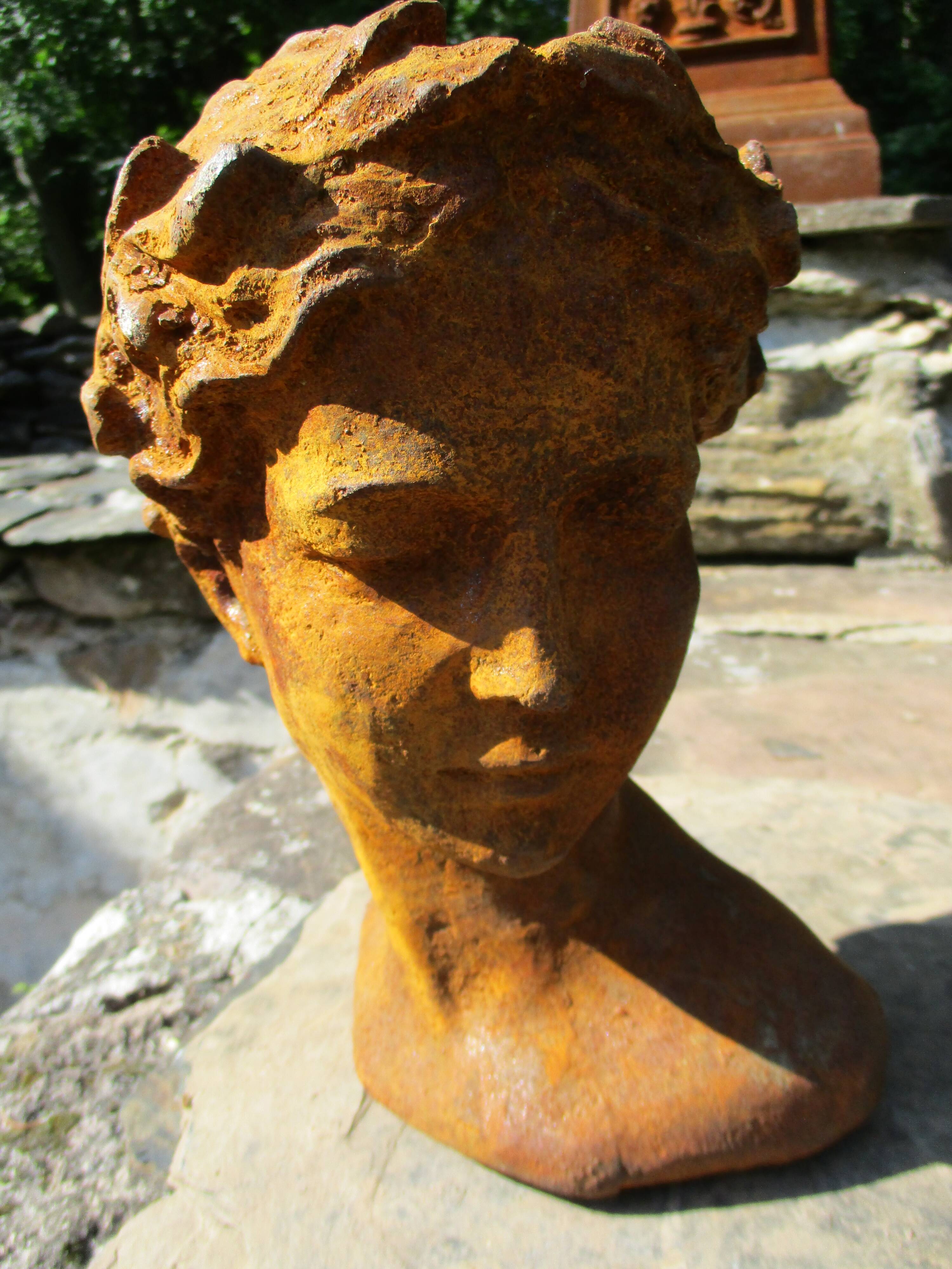 Cast iron sculpture of a woman.
