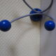 Grey metal wall hook, 4 wooden hangers