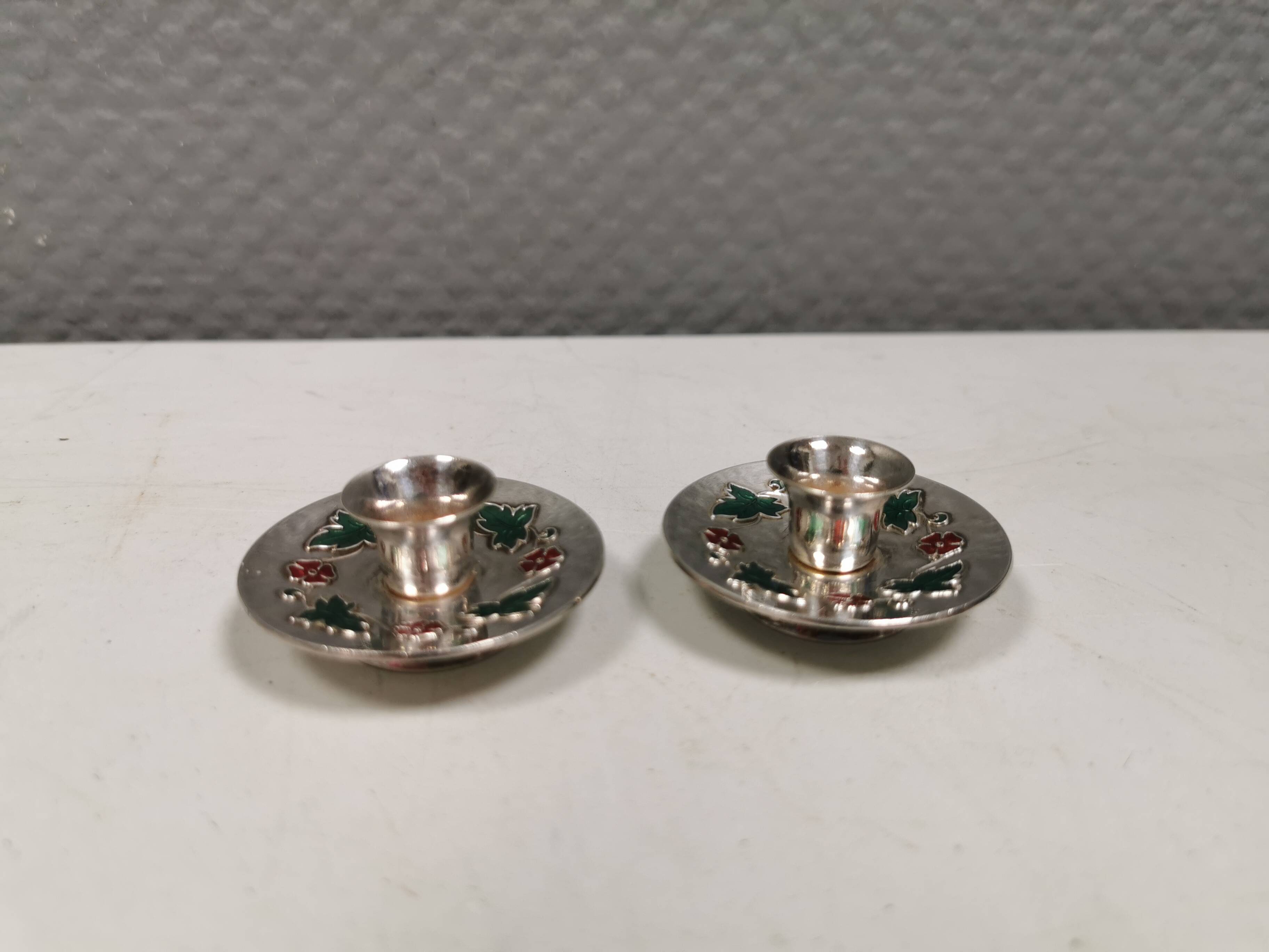 Silver-plated candle holders with inlaid red and green enamel