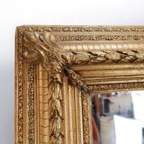 Large gilded wood and stucco mirror with foliage