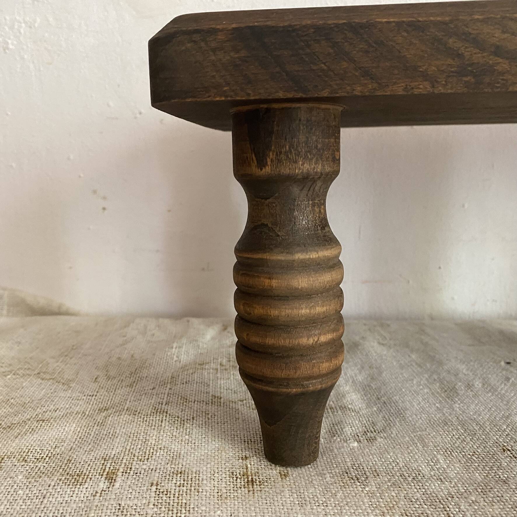Low stool, turned wooden legs.