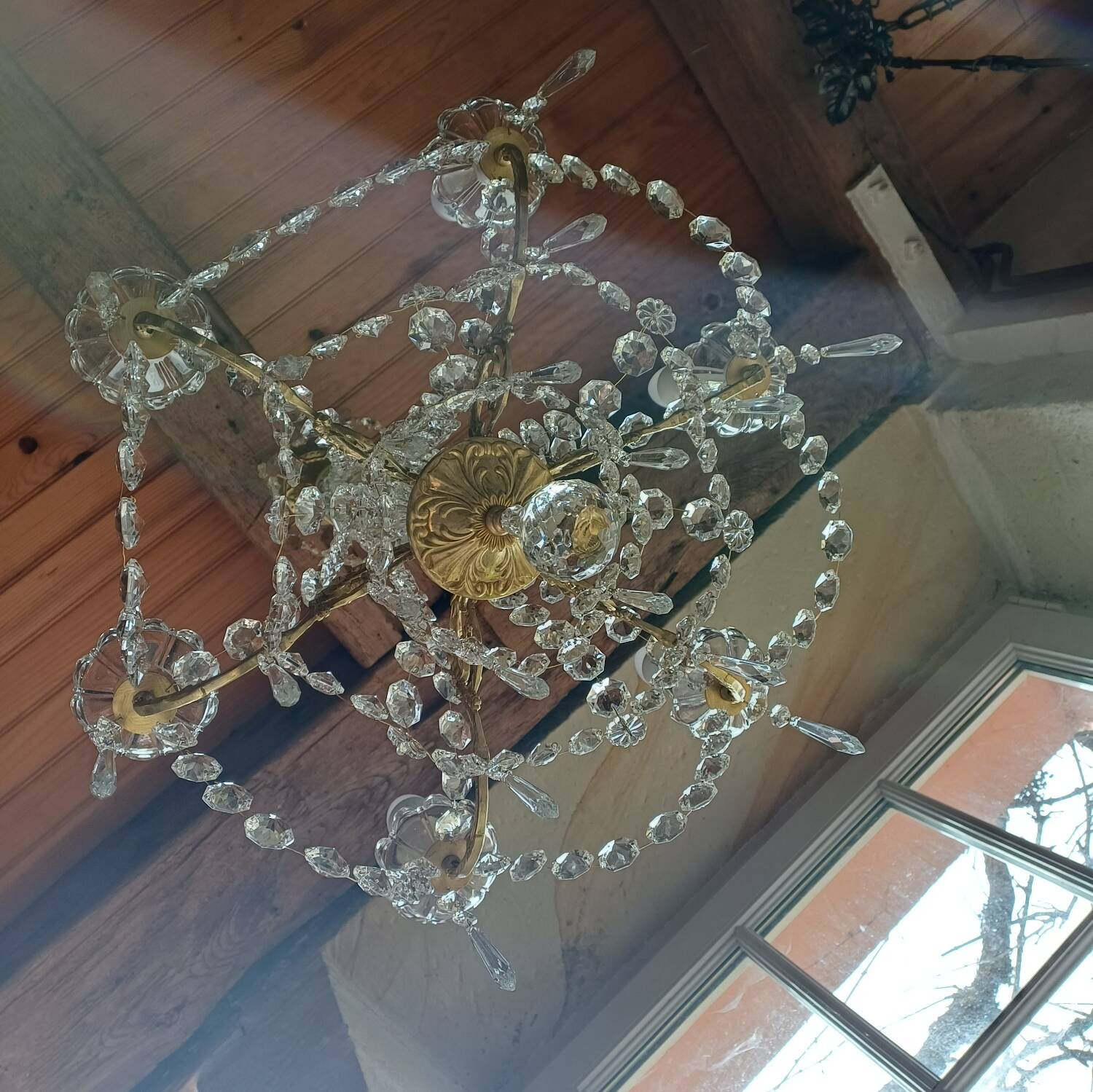 Antique chandelier with pendants in bronze and crystal.