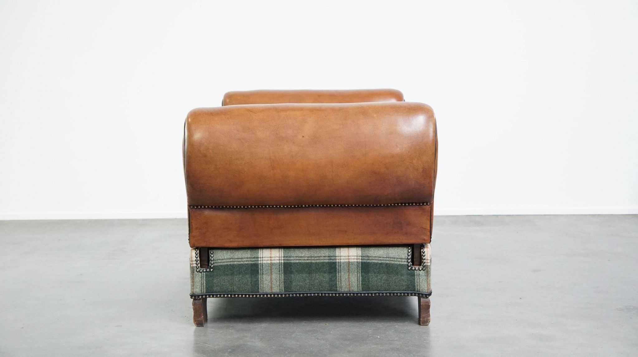 Antique daybed reupholstered with sheepskin and Scottish tartan wool