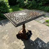 Antique cast iron garden table with decorative openwork top.