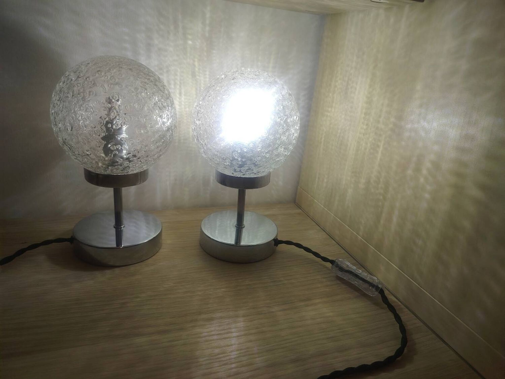 Duo of textured globe lamps with a large play of light.