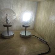 Duo of textured globe lamps with a large play of light.