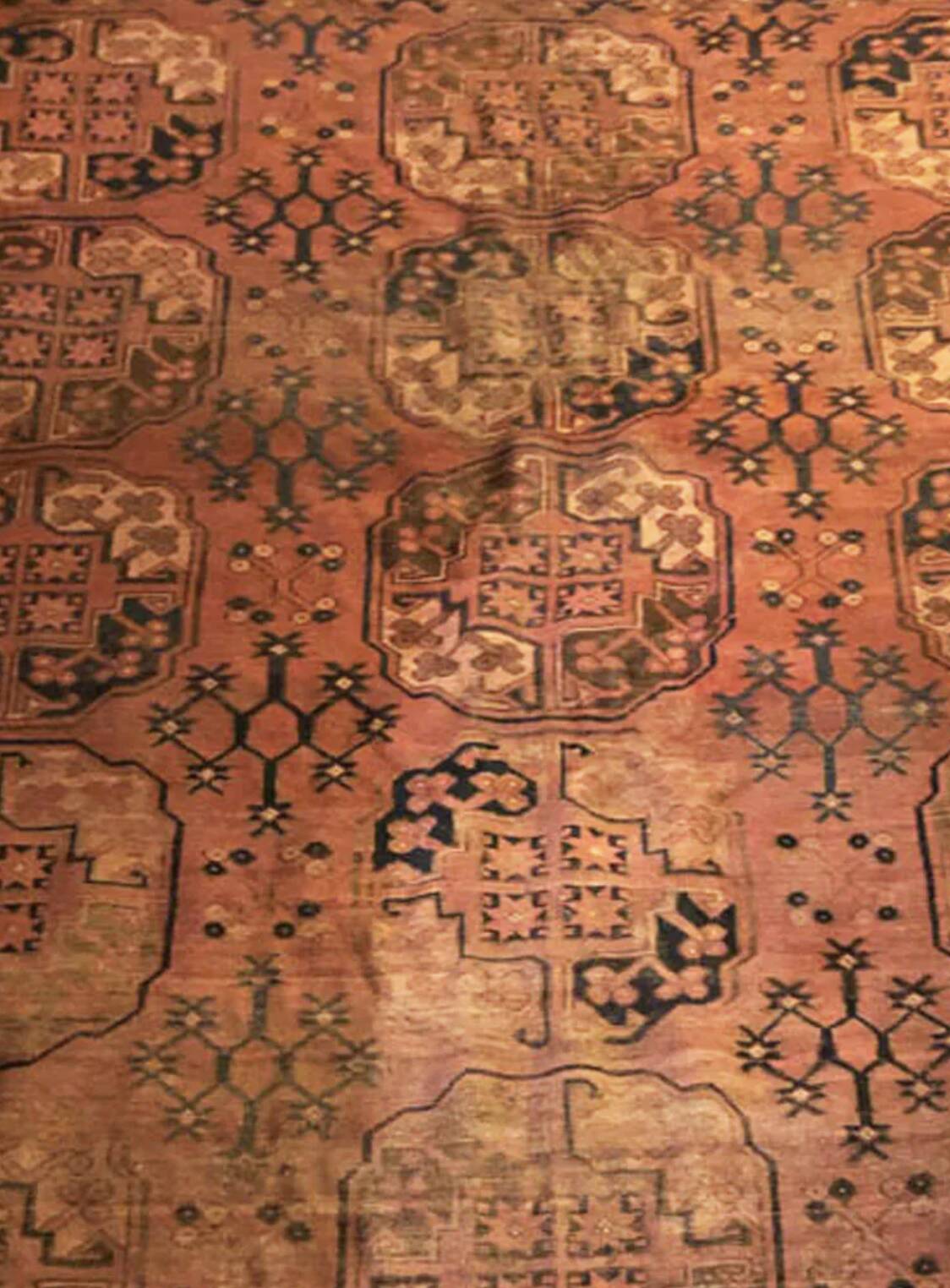 Antique Afghan/Turkmen wool rug, gul patterns, red and brown tones.