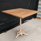 Bistro table with cast iron base and solid teak top