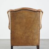 Sheep leather wingback chair with patina