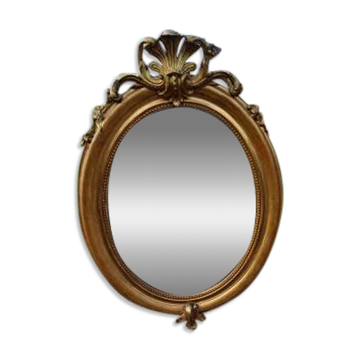 Oval mirror in wood and gilded stucco, 19th century