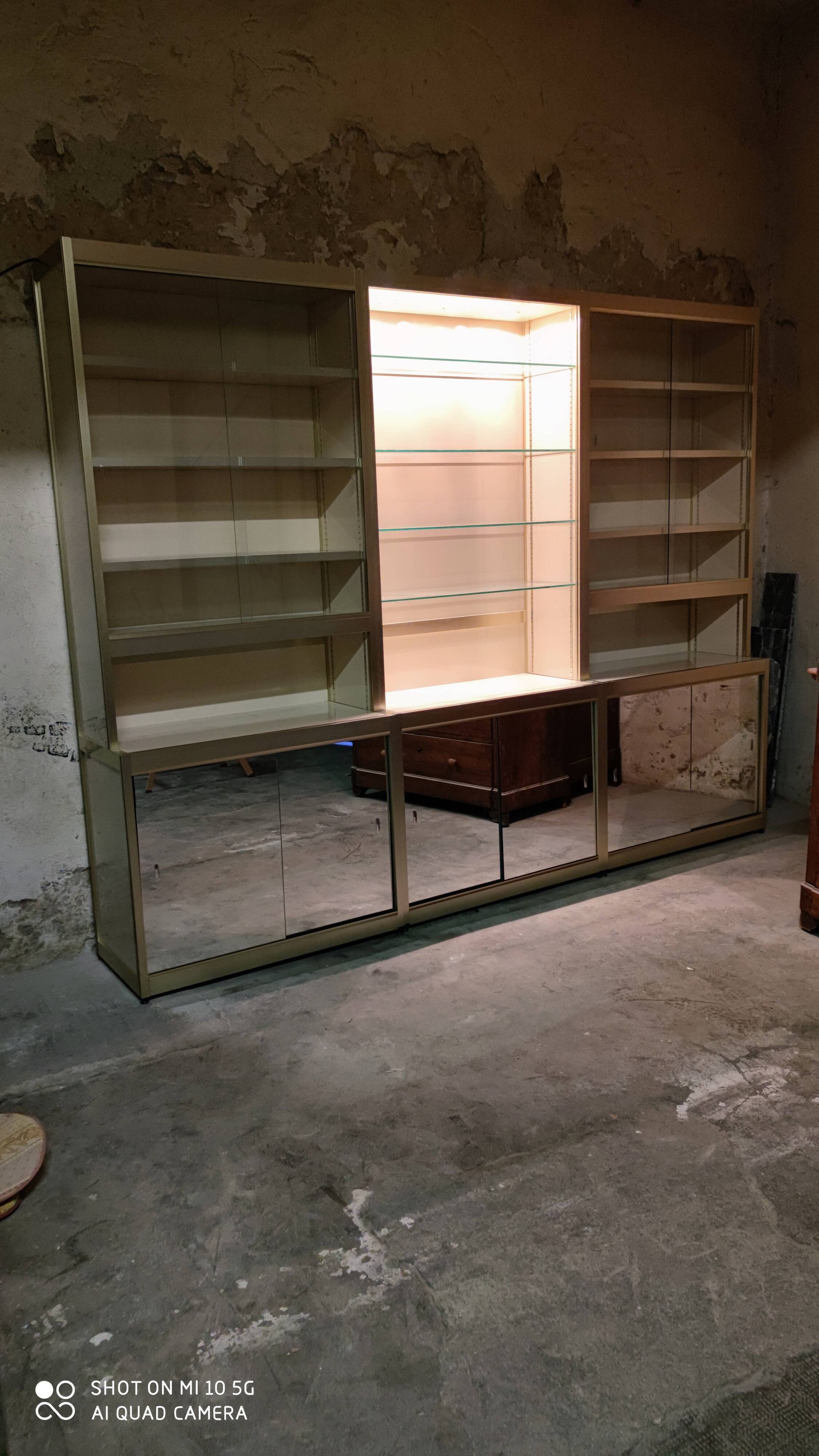 Ivory-colored and matte gold anodized aluminum display bookcase