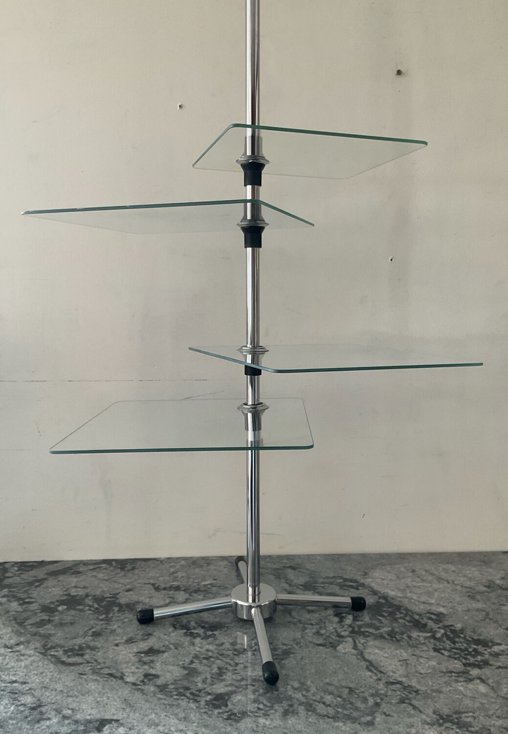 A pair of vintage side tables in glass and chrome metal.