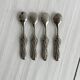 Antique small spoons with a metal bow design