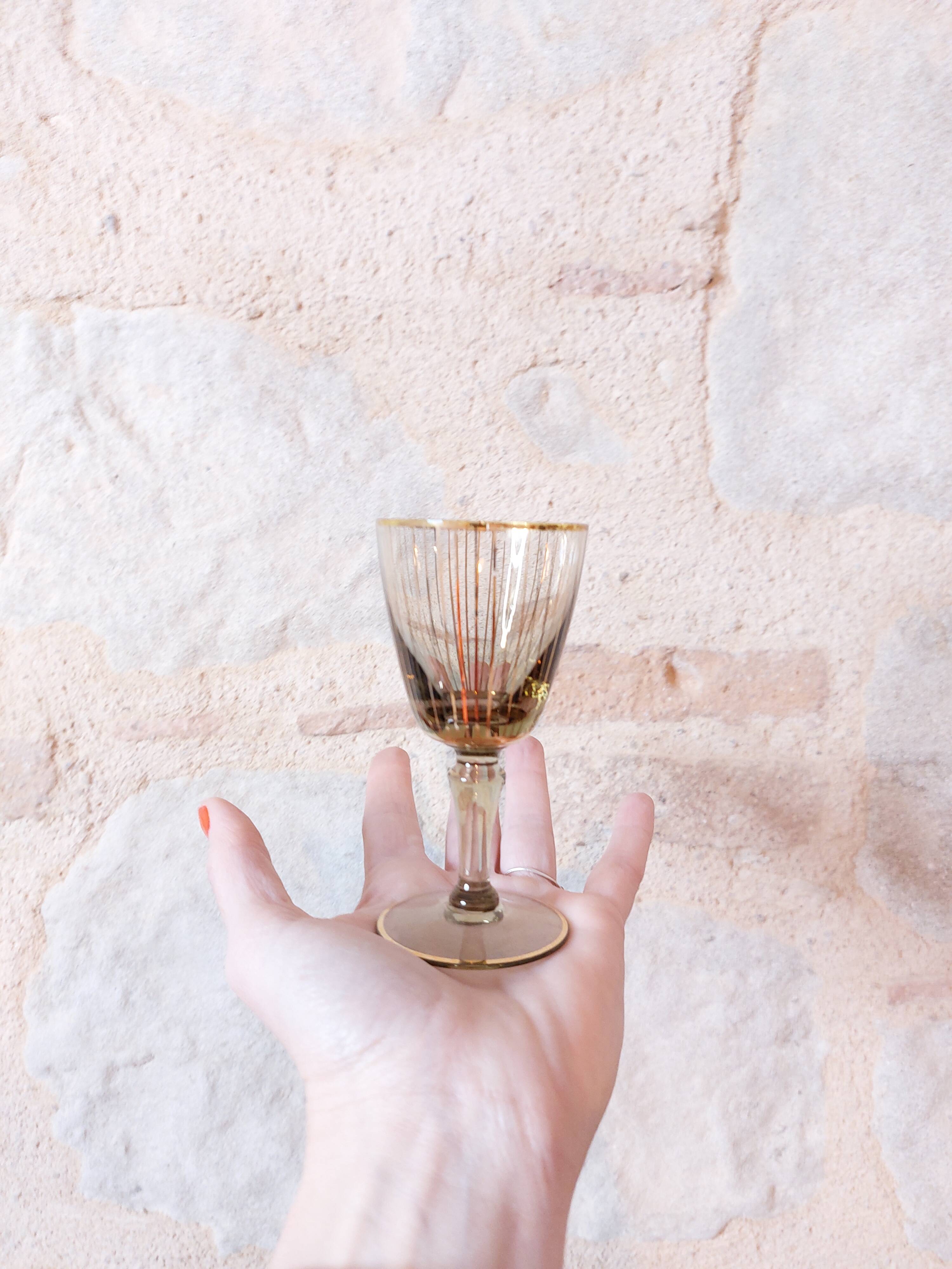 Vintage liqueur service, carafe and 7 amber brown glasses with gold edging
