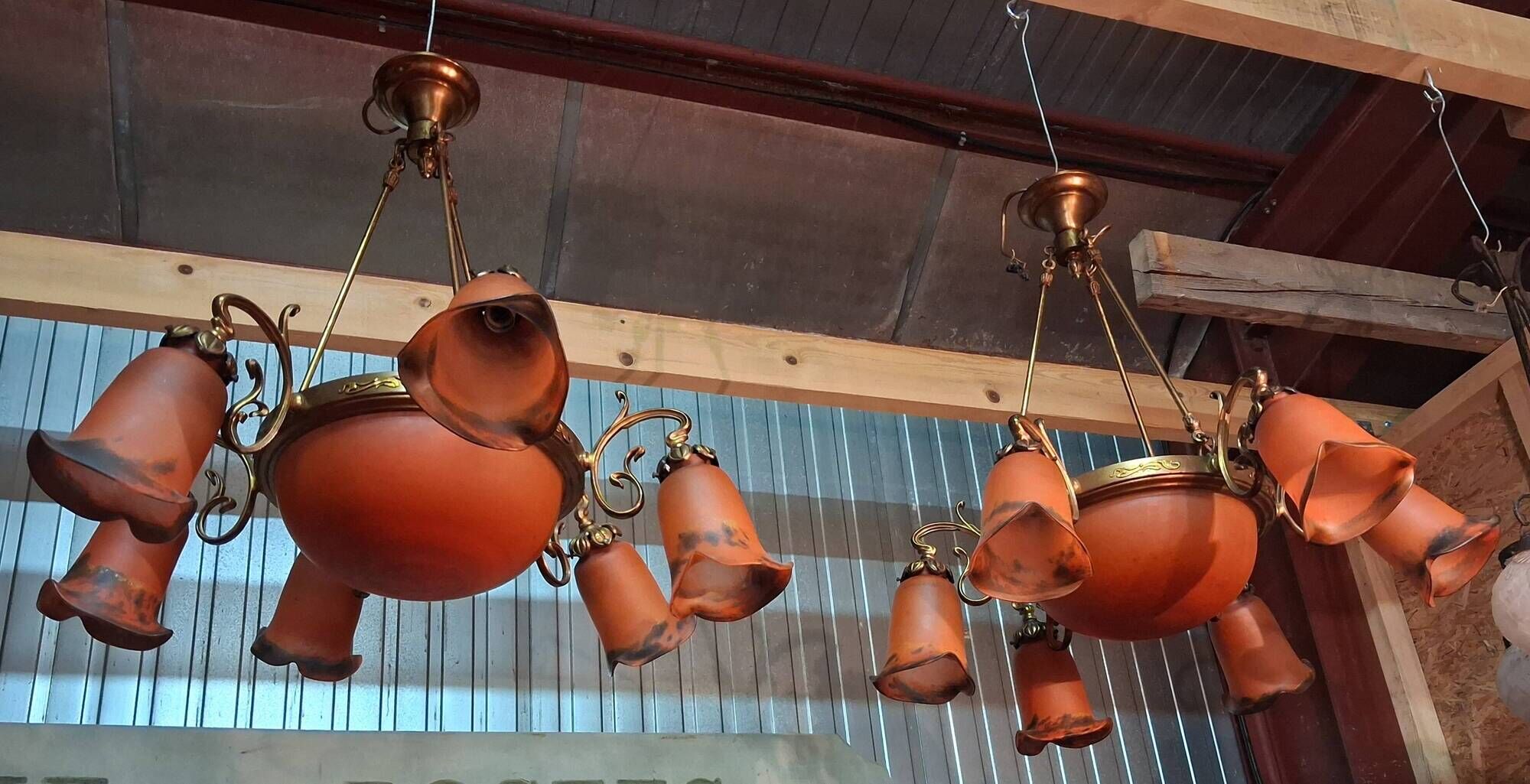 Pair of Art Nouveau style chandeliers in bronze and orange glass paste.
