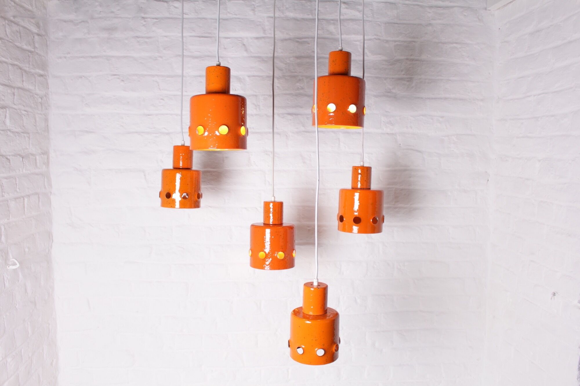 6 Orange enamelled metal suspensions, 1960s