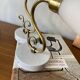 Pair of brass swan neck wall lights with white glass shades.