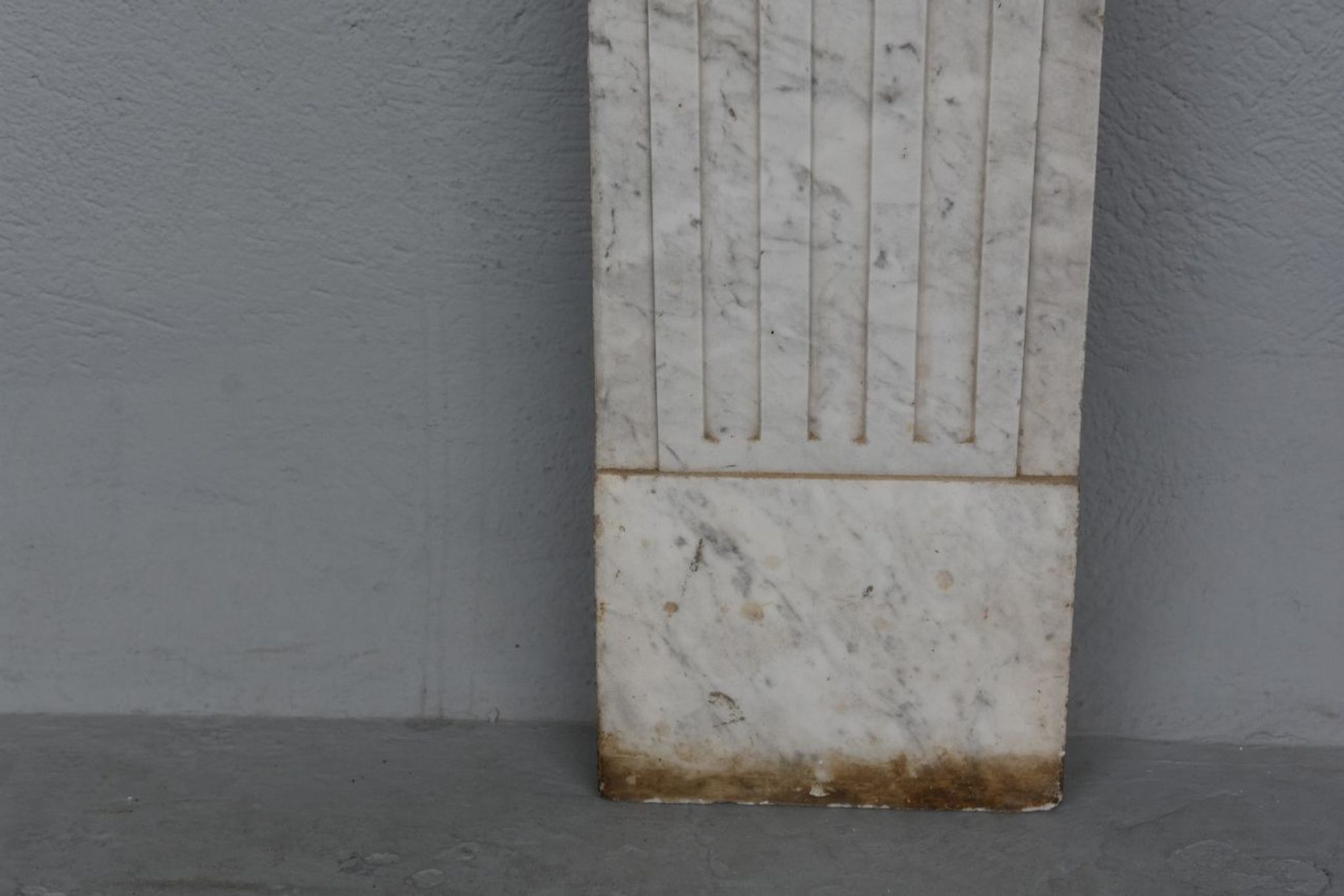 Old fireplace in white marble veined Louis XVI
