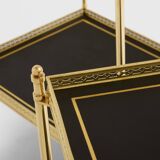 Pair of neoclassical side tables in brass and black leather by Maison Jansen, 1960.