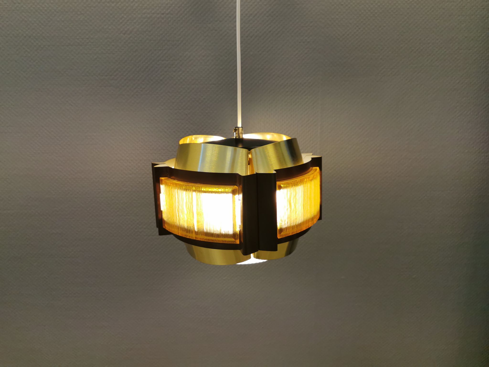 Danish hanging lamp, made in brass colored and brown metal, with yellowish hard pressed plastic deta