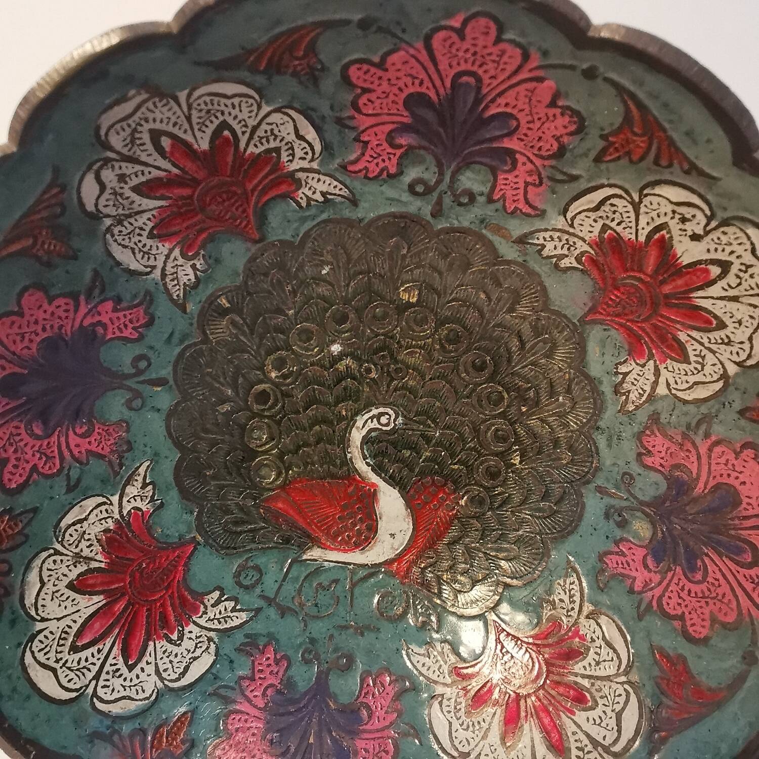 Old Indian brass bowl with peacock decoration