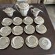 a vintage coffee or tea set in white porcelain with patterns and