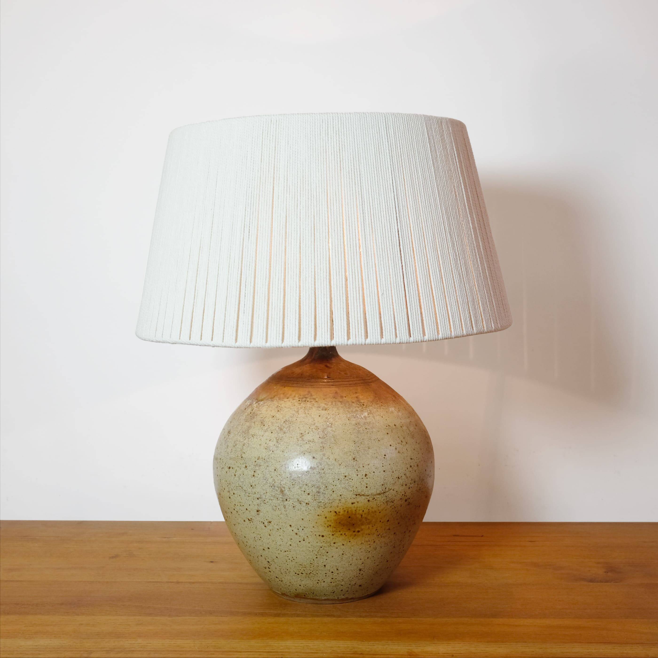 Large stone lamp with a cotton shade.