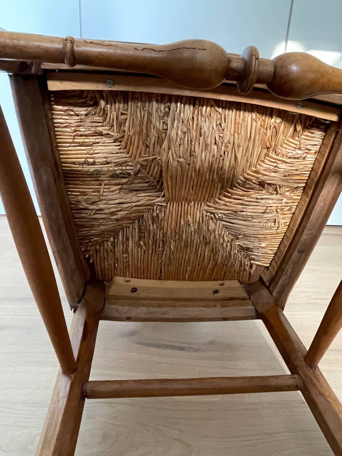 19th century straw chair with carved peacock back