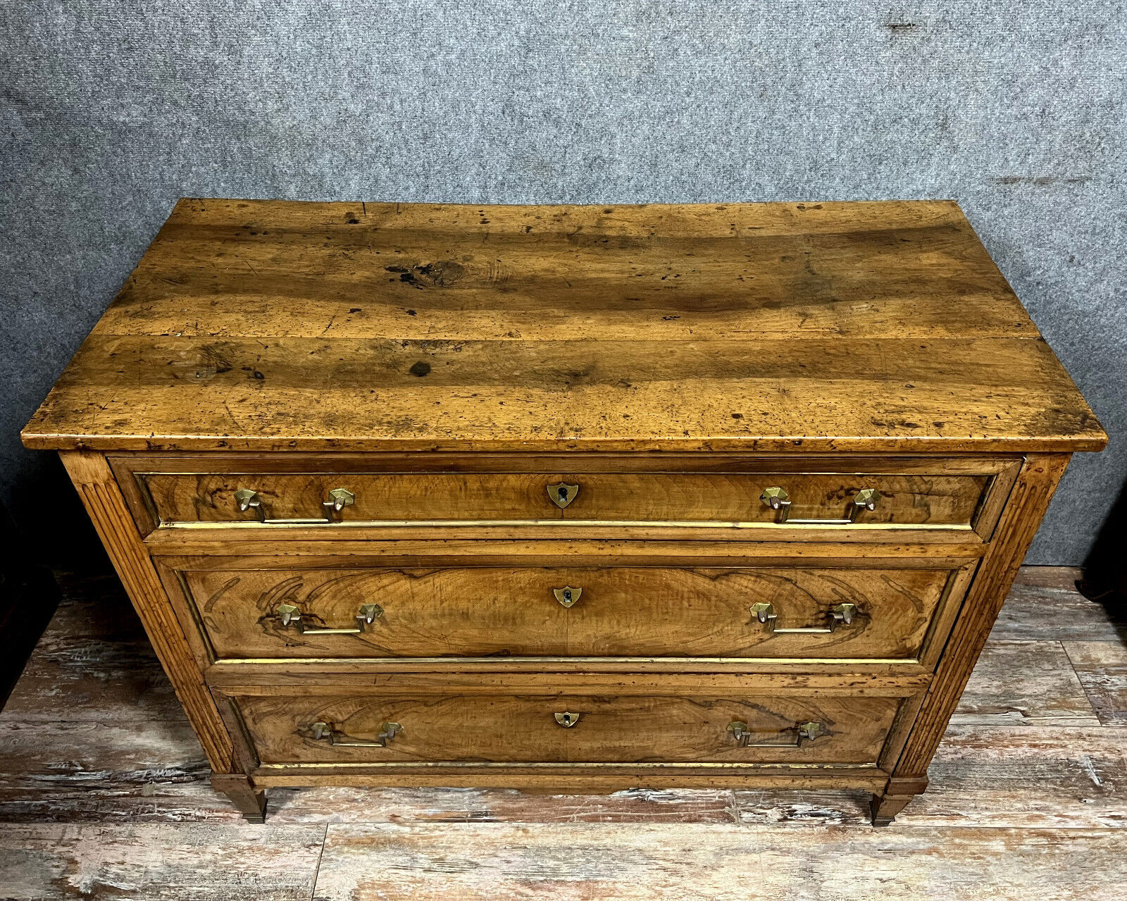 Louis XVI period chest of drawers in walnut and gilded brass nets circa 1780