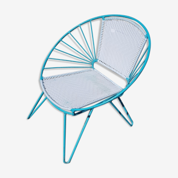 Old relax armchair in turquoise metal